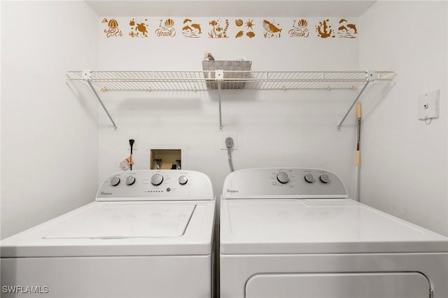 washroom with washing machine and clothes dryer