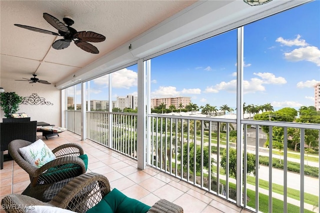 sunroom featuring ceiling fan