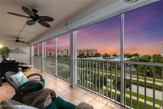 sunroom / solarium featuring ceiling fan