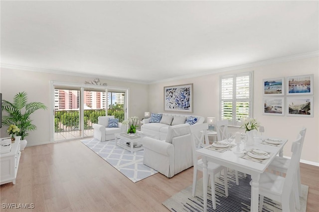 living room with ornamental molding and light wood-type flooring