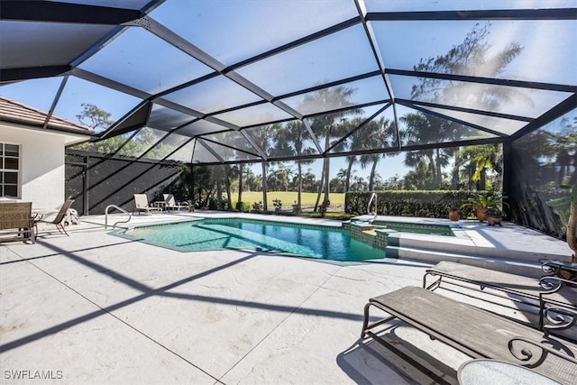 view of swimming pool featuring a patio area, an in ground hot tub, and glass enclosure