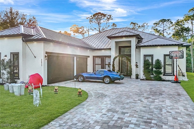 view of front of property with a garage and a front lawn