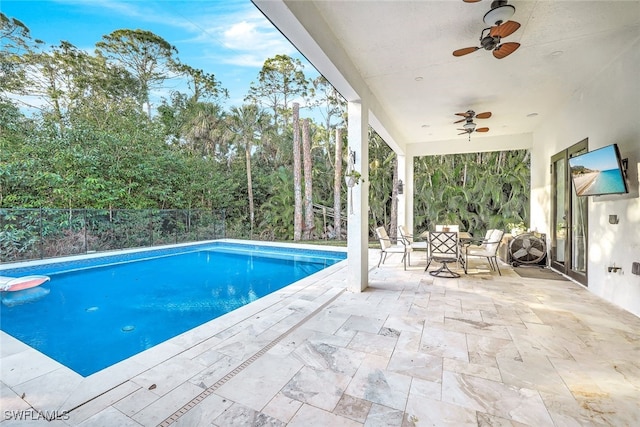 view of pool with ceiling fan and a patio