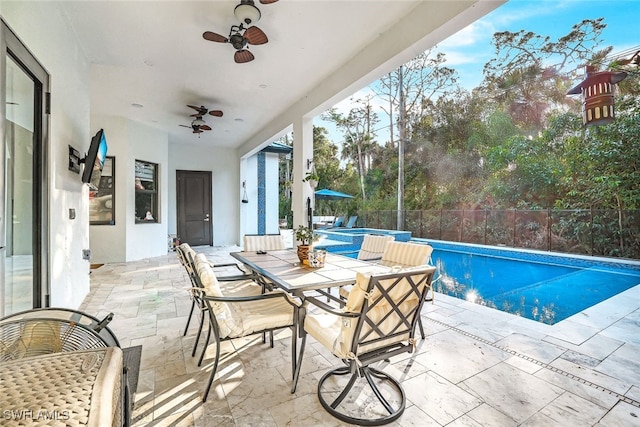 view of swimming pool featuring ceiling fan and a patio area