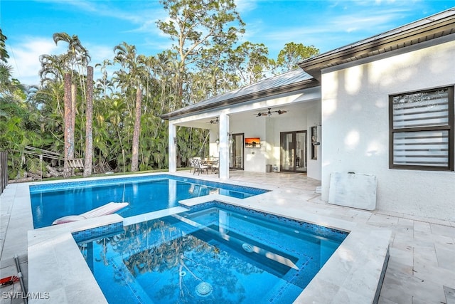 view of swimming pool featuring an in ground hot tub, ceiling fan, and a patio