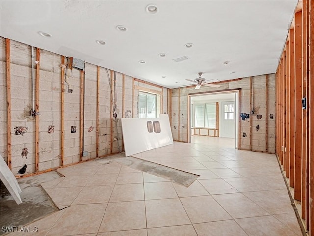 empty room with ceiling fan and light tile patterned flooring