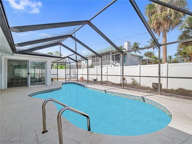 view of swimming pool featuring a lanai and a patio area