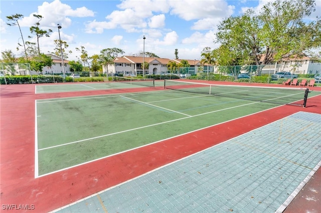 view of tennis court featuring basketball hoop