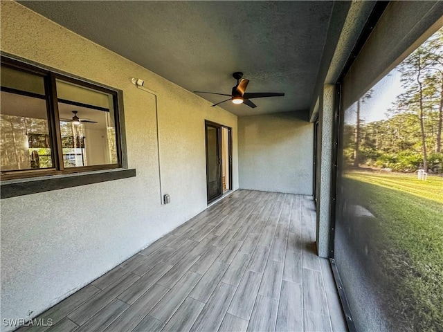 exterior space with ceiling fan and a healthy amount of sunlight