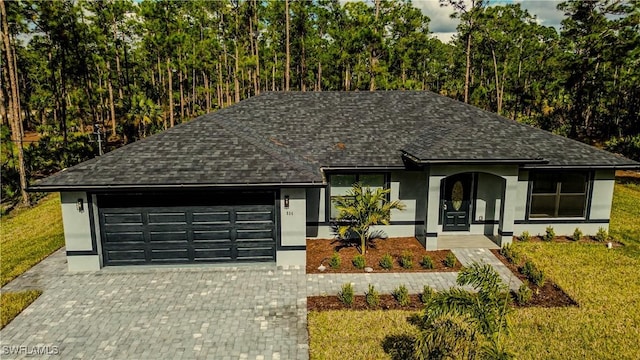 view of front of home featuring a garage and a front lawn