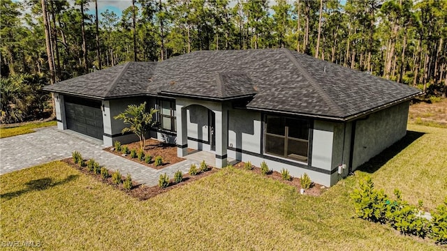 view of front of house featuring a garage and a front lawn