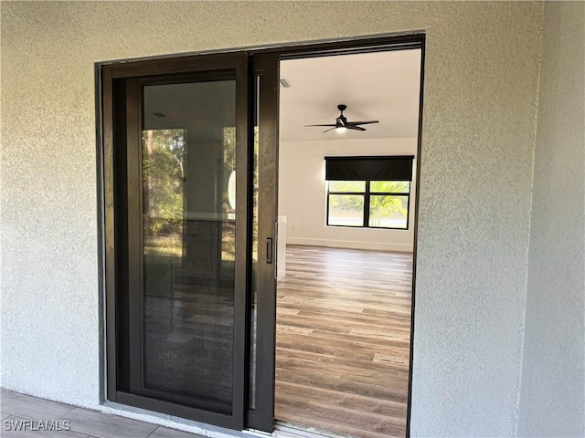 entrance to property with ceiling fan