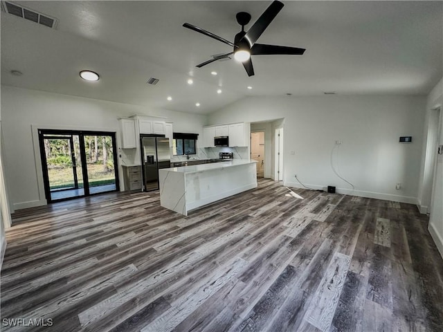 kitchen featuring white cabinetry, ceiling fan, hardwood / wood-style floors, vaulted ceiling, and appliances with stainless steel finishes