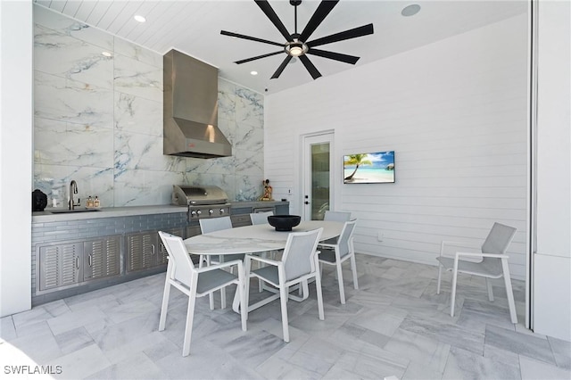 interior space featuring tile walls, ceiling fan, and sink