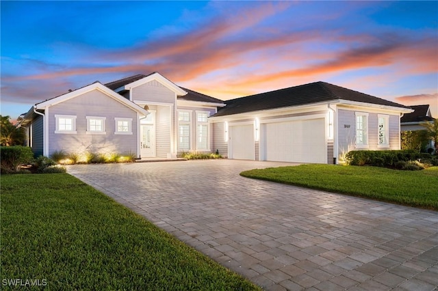 ranch-style home with a yard and a garage