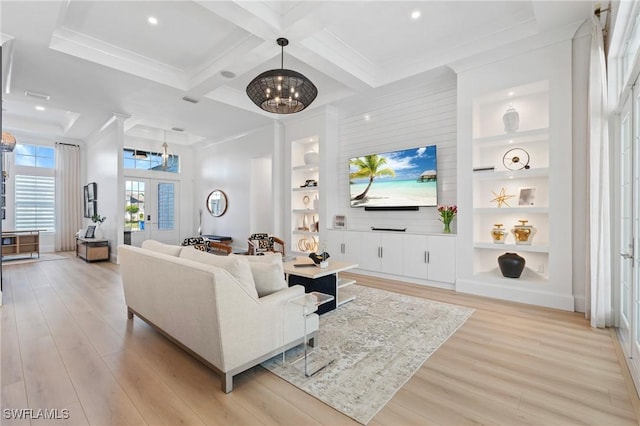 living room featuring french doors, light hardwood / wood-style flooring, a chandelier, and built in features