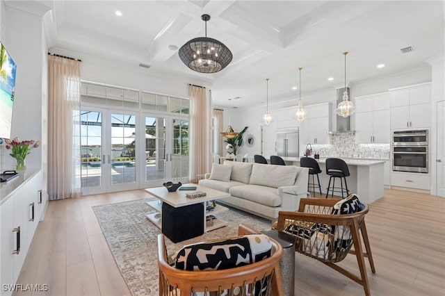 living room with french doors, coffered ceiling, beamed ceiling, a notable chandelier, and light wood-type flooring