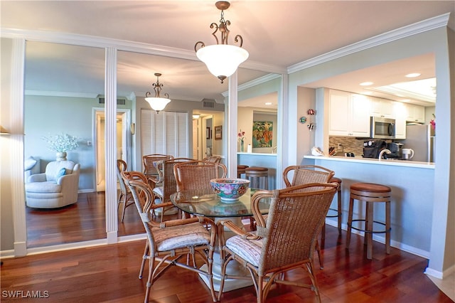 dining space with crown molding and dark wood-type flooring