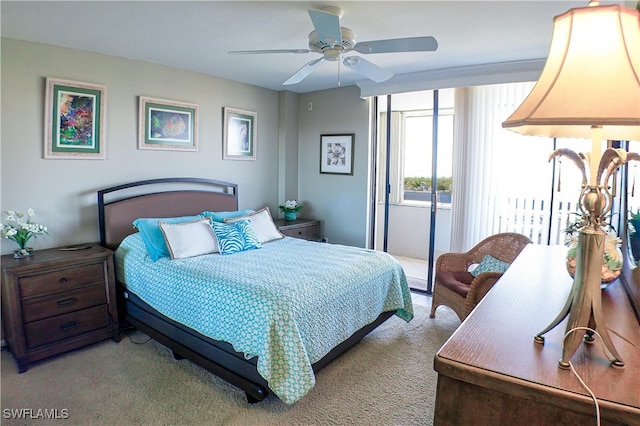 carpeted bedroom with ceiling fan and access to outside