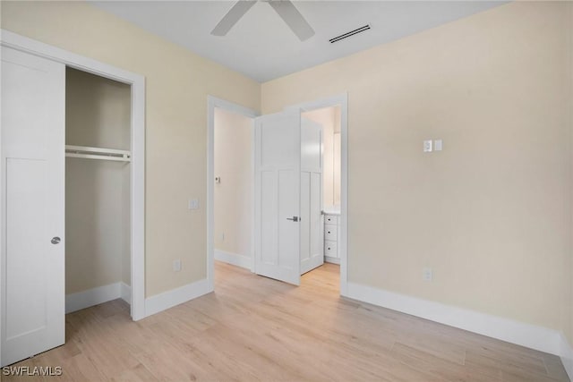 unfurnished bedroom featuring a closet, light hardwood / wood-style floors, and ceiling fan