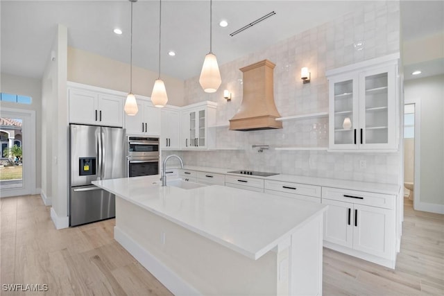 kitchen with white cabinets, sink, stainless steel appliances, and custom exhaust hood