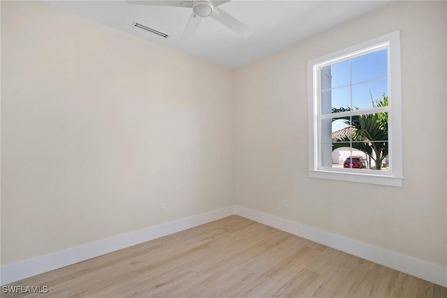 empty room featuring ceiling fan and light hardwood / wood-style flooring