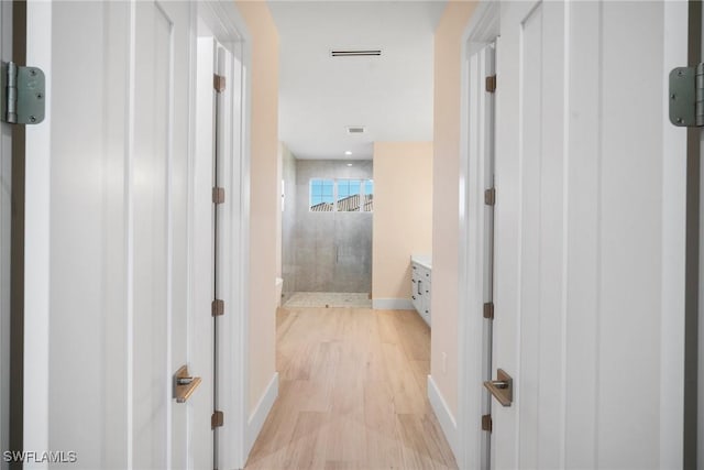 hall with light hardwood / wood-style floors