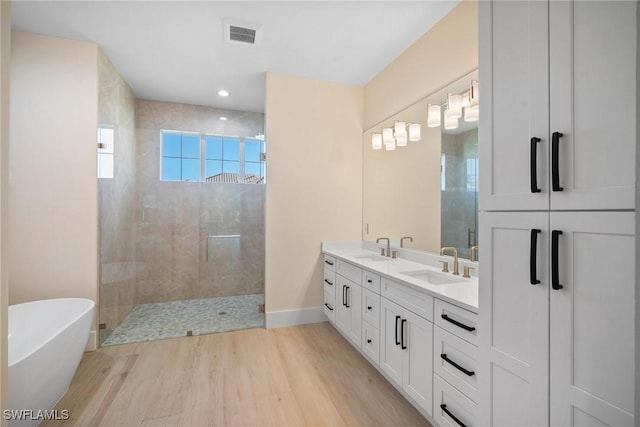 bathroom with vanity, hardwood / wood-style flooring, and separate shower and tub