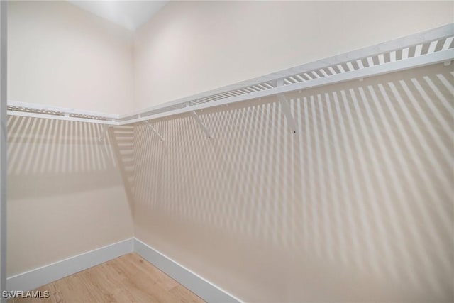 spacious closet featuring hardwood / wood-style floors