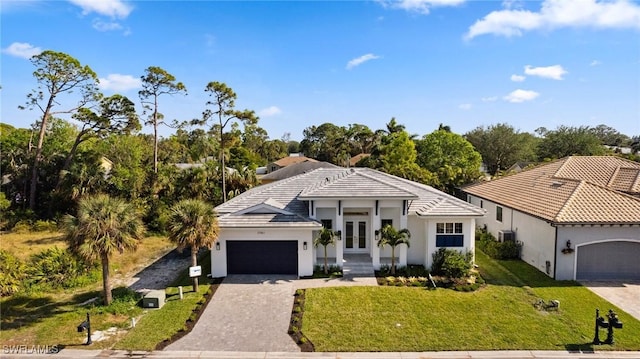 view of front of house with a garage, a front yard, and french doors