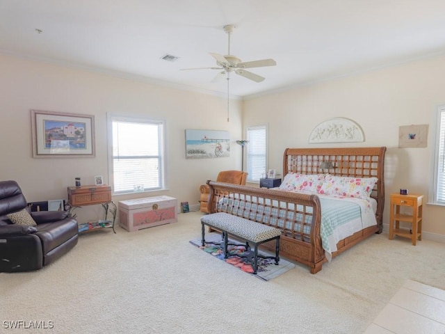 carpeted bedroom with ceiling fan and ornamental molding