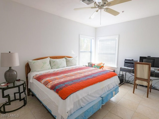 tiled bedroom featuring ceiling fan