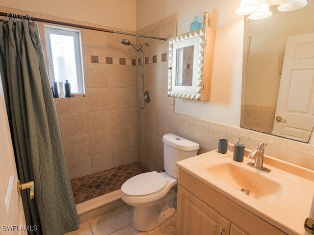 bathroom featuring a shower with shower curtain, vanity, toilet, and tile patterned floors