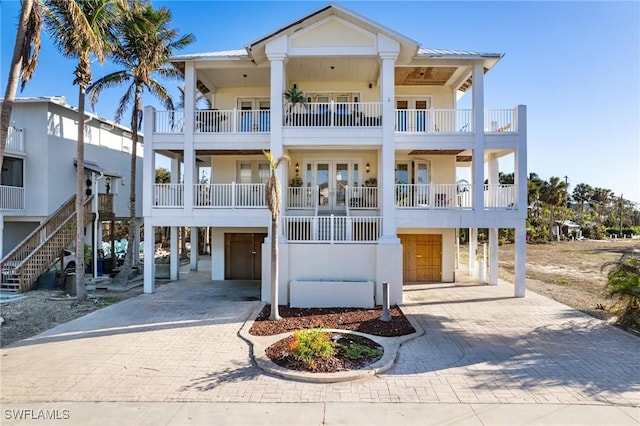 view of front of property with french doors and a carport