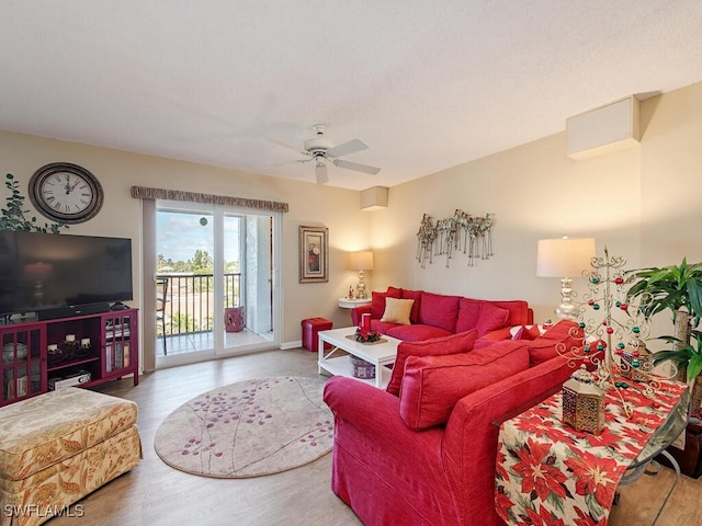 living room with ceiling fan and wood-type flooring