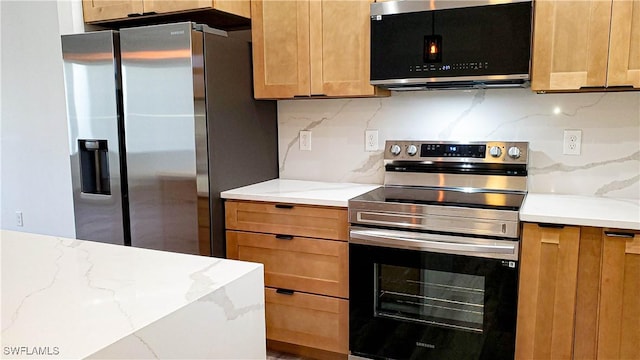 kitchen with decorative backsplash, light stone countertops, and appliances with stainless steel finishes