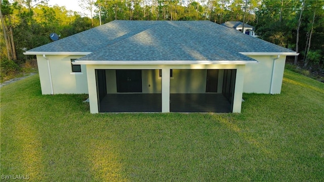 rear view of house featuring a lawn