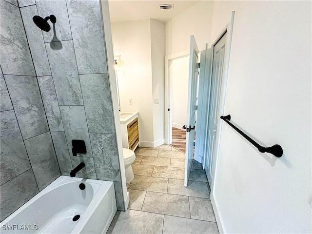 full bathroom with tiled shower / bath, vanity, and toilet