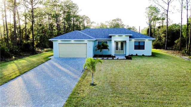 view of front of home featuring a garage and a front lawn