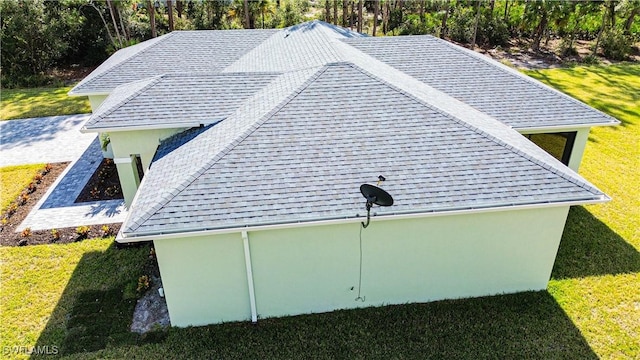 view of property exterior with a yard