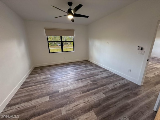 empty room with ceiling fan and dark hardwood / wood-style flooring