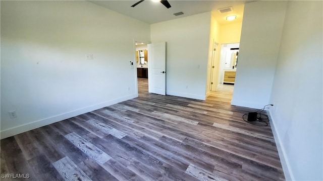 spare room with ceiling fan and dark wood-type flooring