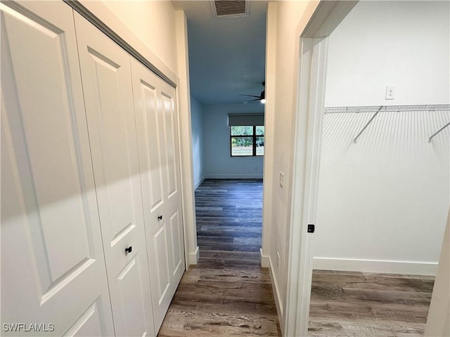 hallway with dark hardwood / wood-style flooring