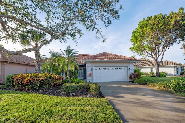 view of front of property with a front yard and a garage