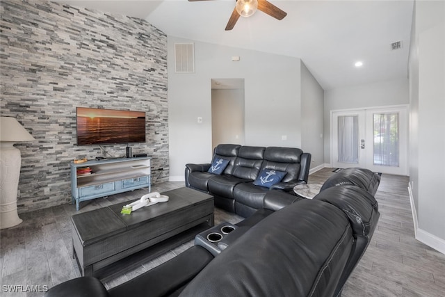 living room featuring ceiling fan, french doors, lofted ceiling, and hardwood / wood-style flooring