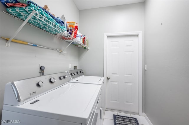 laundry area featuring tile patterned flooring and washer and dryer