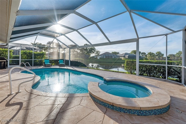 view of pool featuring glass enclosure, a patio area, a water view, and an in ground hot tub