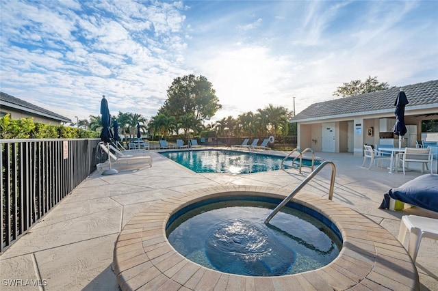 view of pool with a patio area and a community hot tub