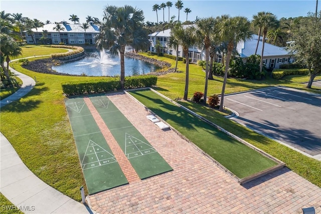 view of community featuring a water view and a lawn