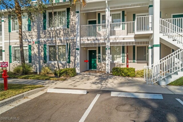 7930 Mahogany Run Ln Unit 814, Naples, FL 34113 - view of property with stairway and uncovered parking